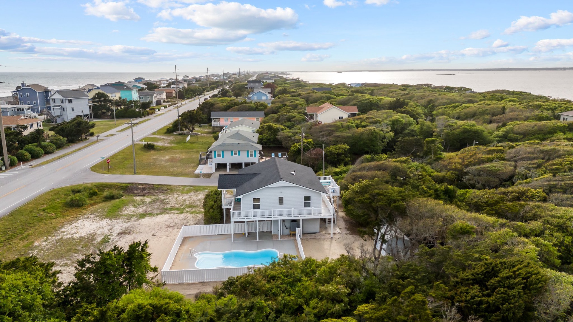 Coastal retreat with private pool nestled among lush maritime forest, just steps from pristine beaches and charming oceanfront community.