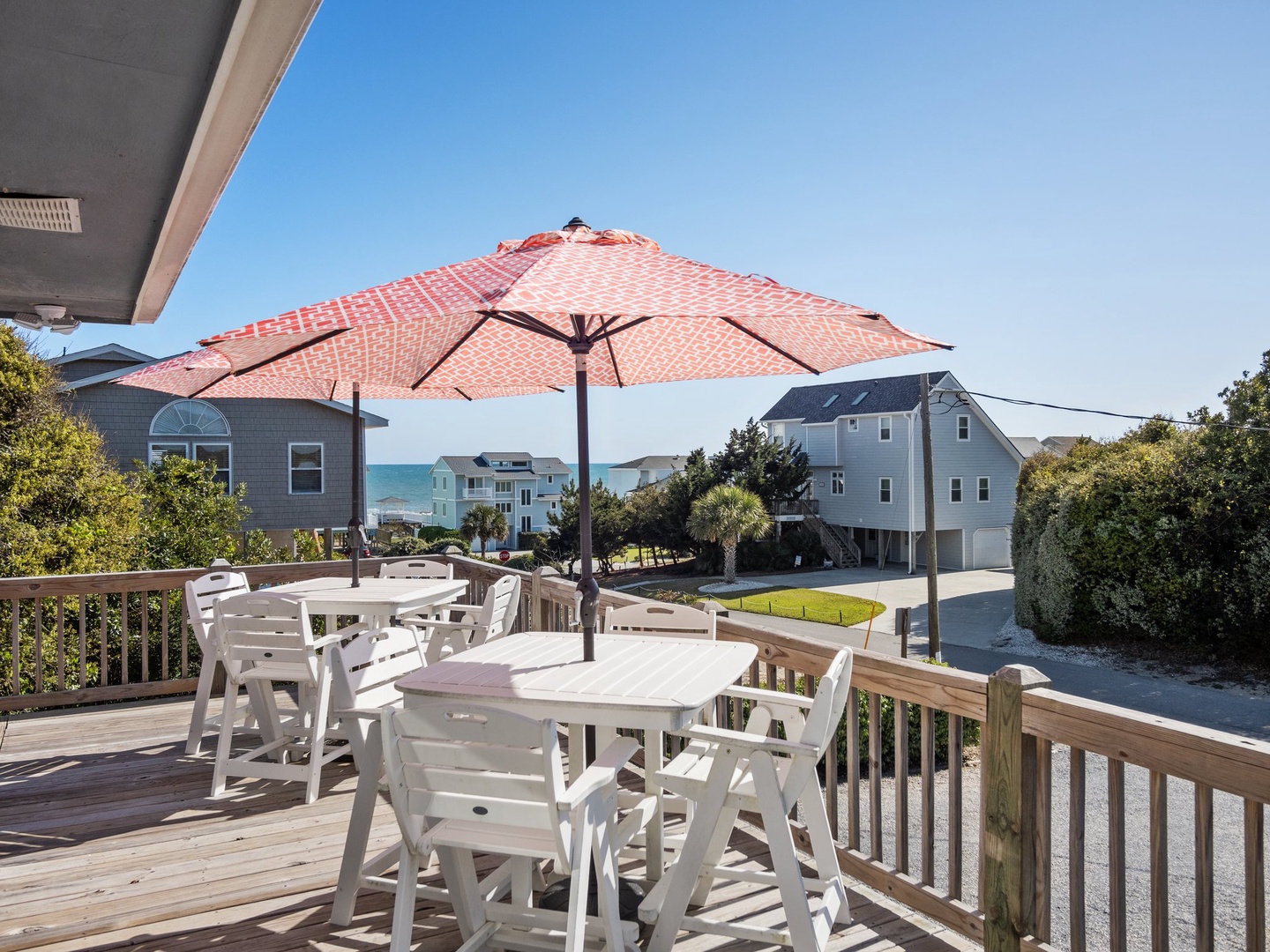 Enjoy coastal mornings on your private deck with ocean glimpses and neighborhood charm stretching toward the horizon.