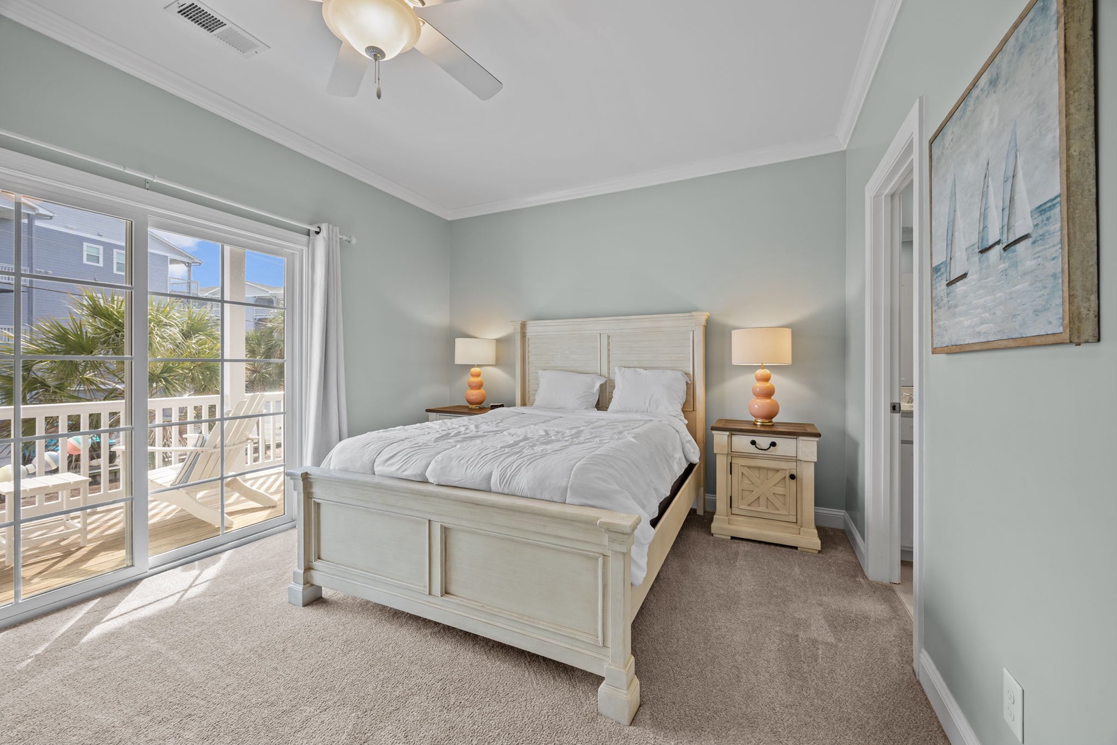 Wake up to coastal charm in your peaceful bedroom, where soft ocean breezes flow through French doors onto your private balcony.