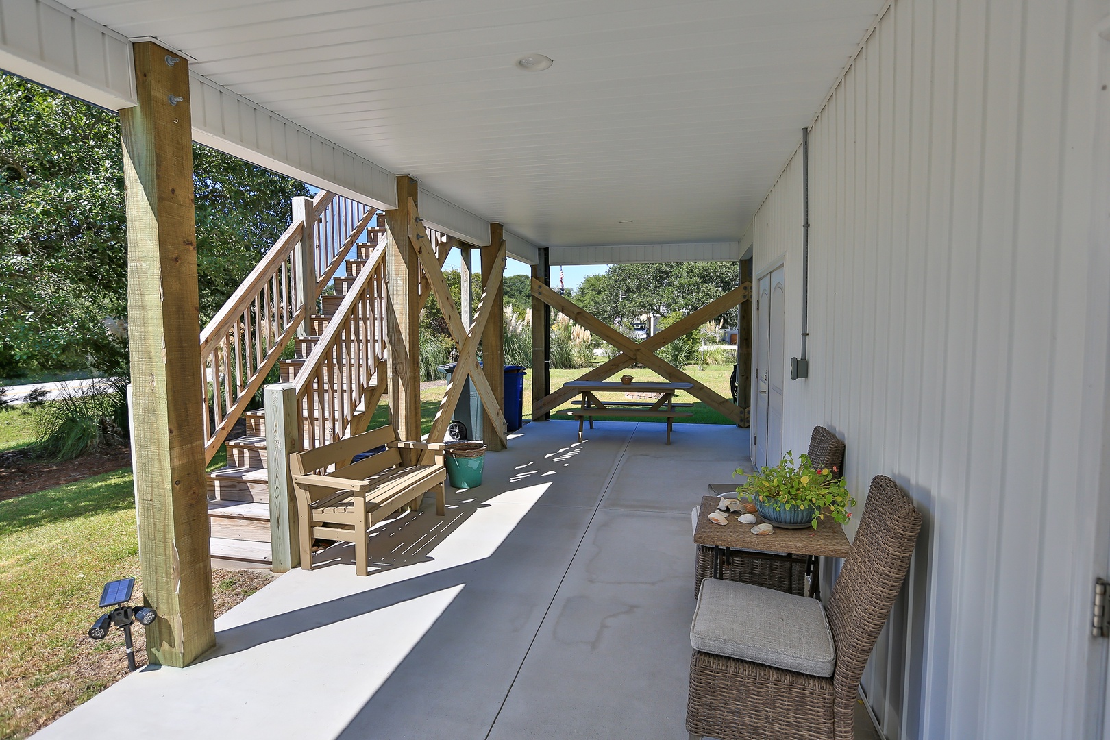 Your covered patio offers peaceful seating with wicker chairs where you can relax while watching the kids play in the yard.