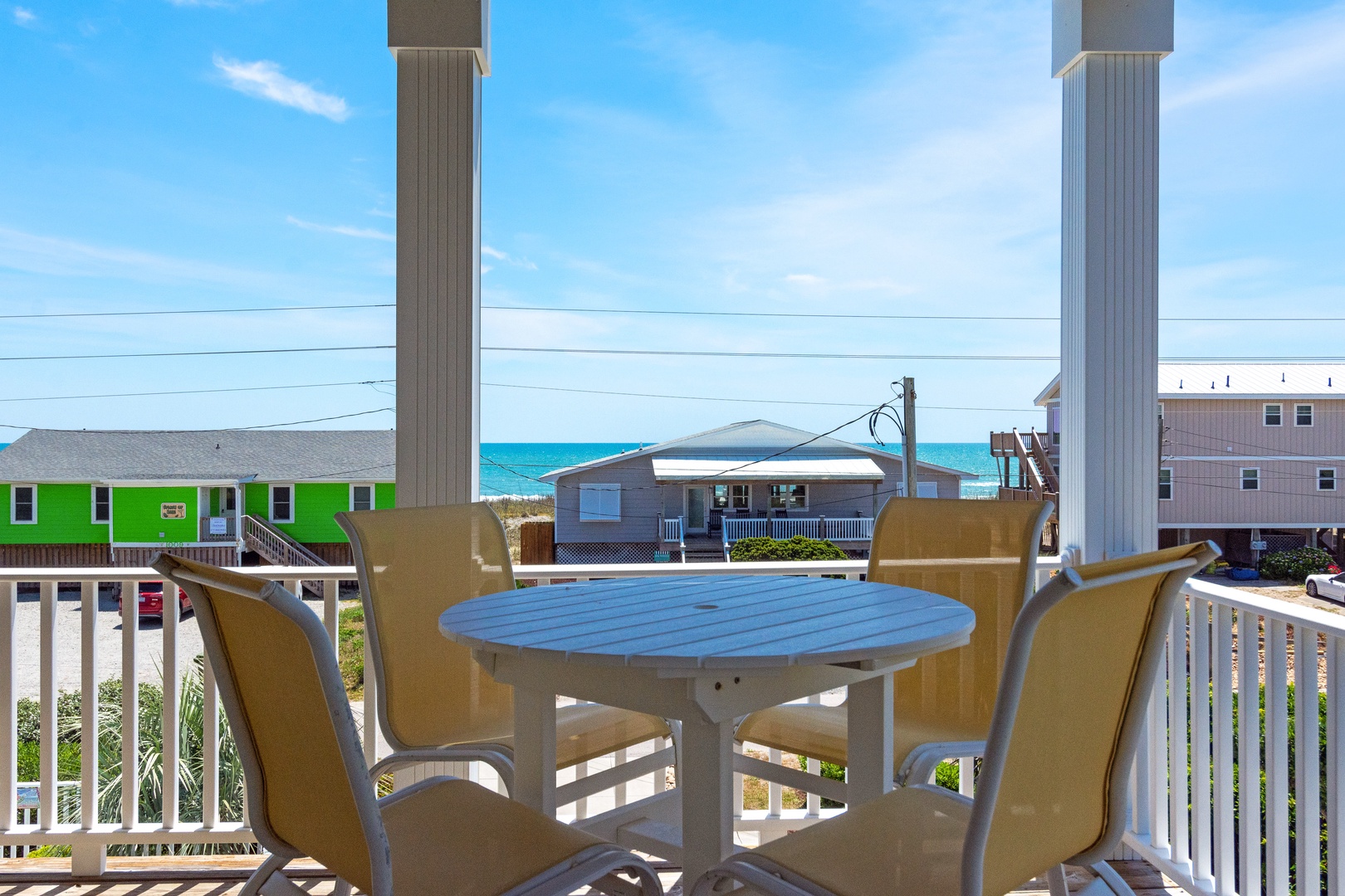Enjoy morning coffee at your private table while taking in stunning ocean views from your covered balcony.