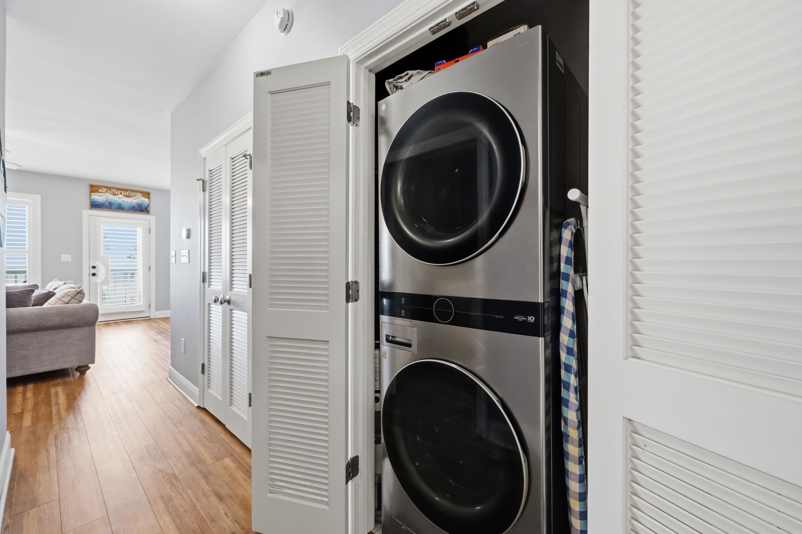 Modern stacked washer and dryer tucked neatly into your hallway closet make laundry day effortless during your stay.