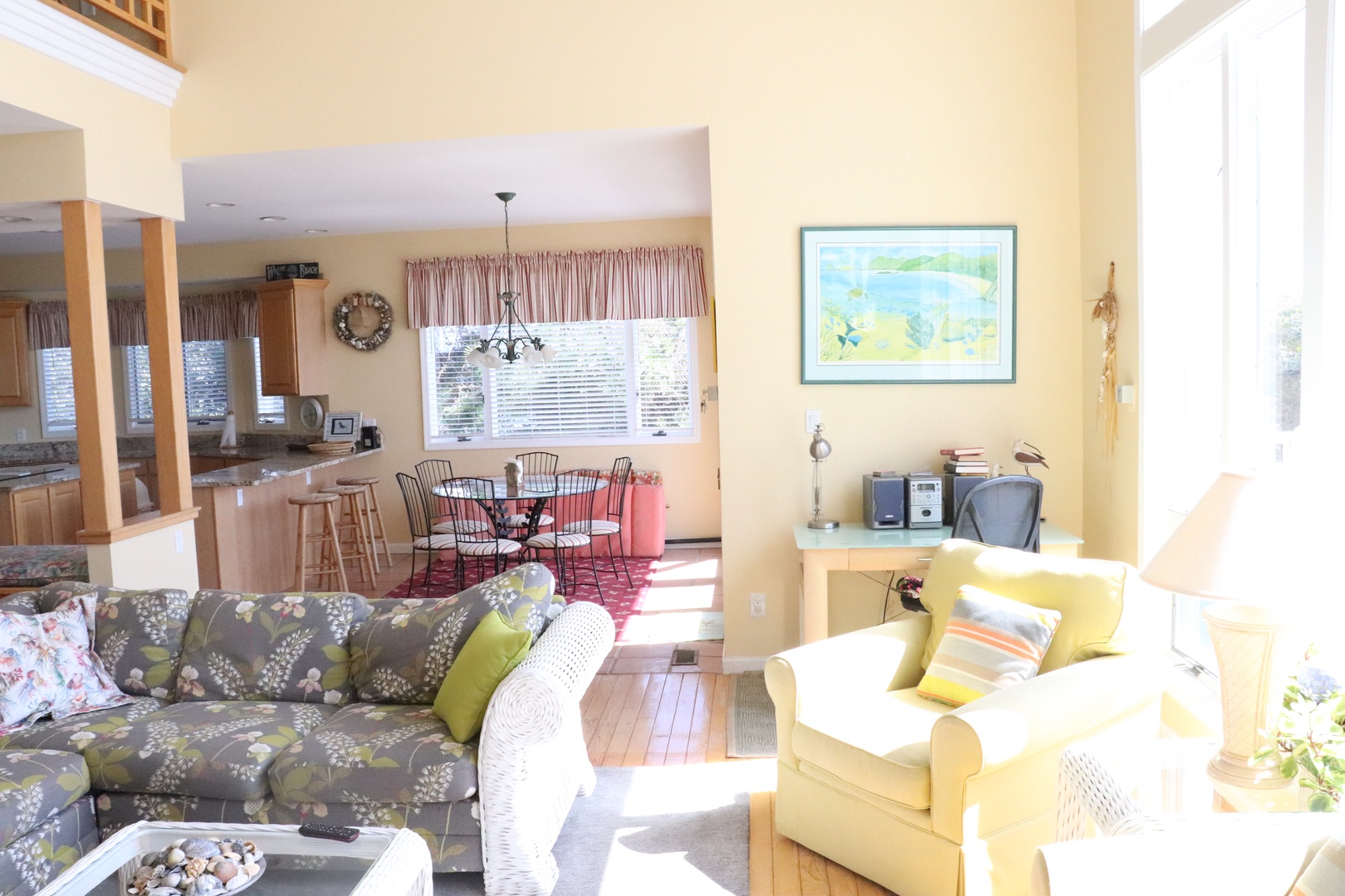 Settle into your bright, open living space where golden sunlight streams through large windows, creating a warm atmosphere for relaxation.