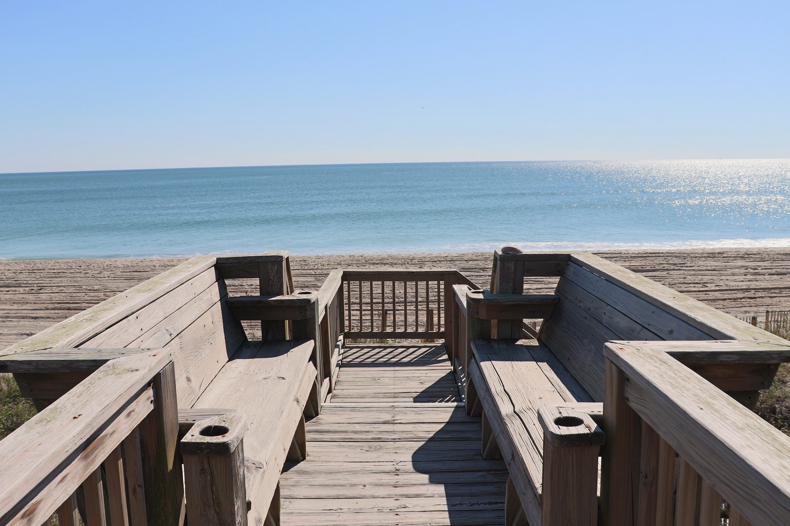 Step onto your private deck overlooking pristine beach and sparkling ocean. Built-in benches with cup holders make this the perfect spot for morning coffee or sunset drinks.