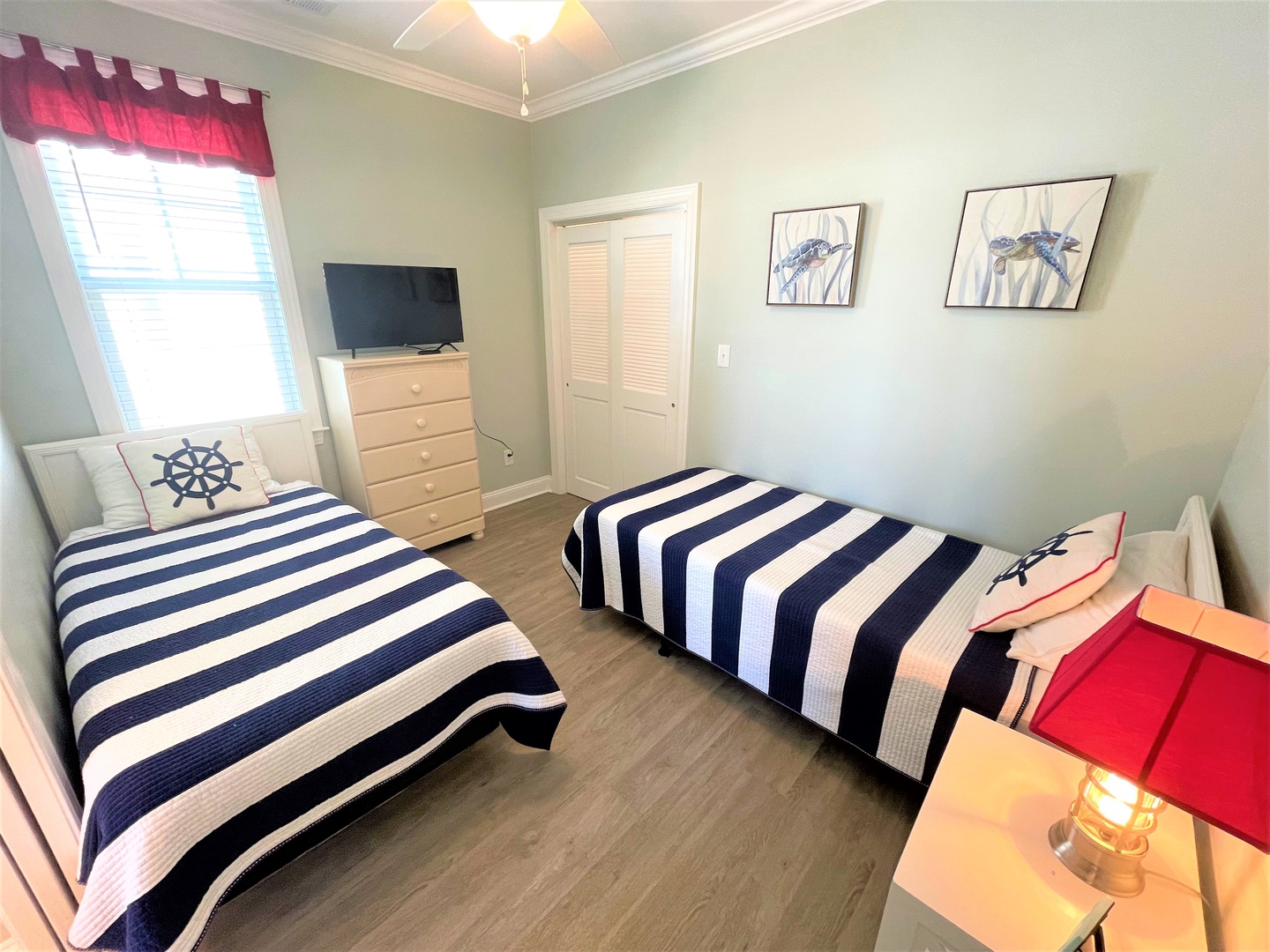 Your nautical twin bedroom features crisp navy stripes and maritime touches perfect for family stays.