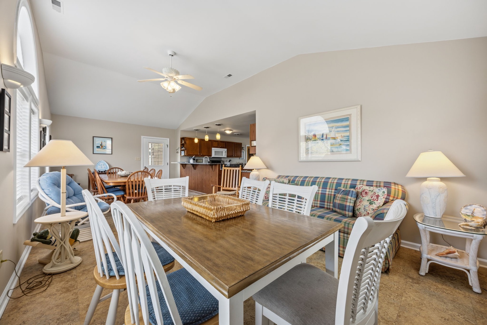 Gather around your spacious dining table for memorable meals, with warm lighting and coastal décor creating the perfect atmosphere for family time.