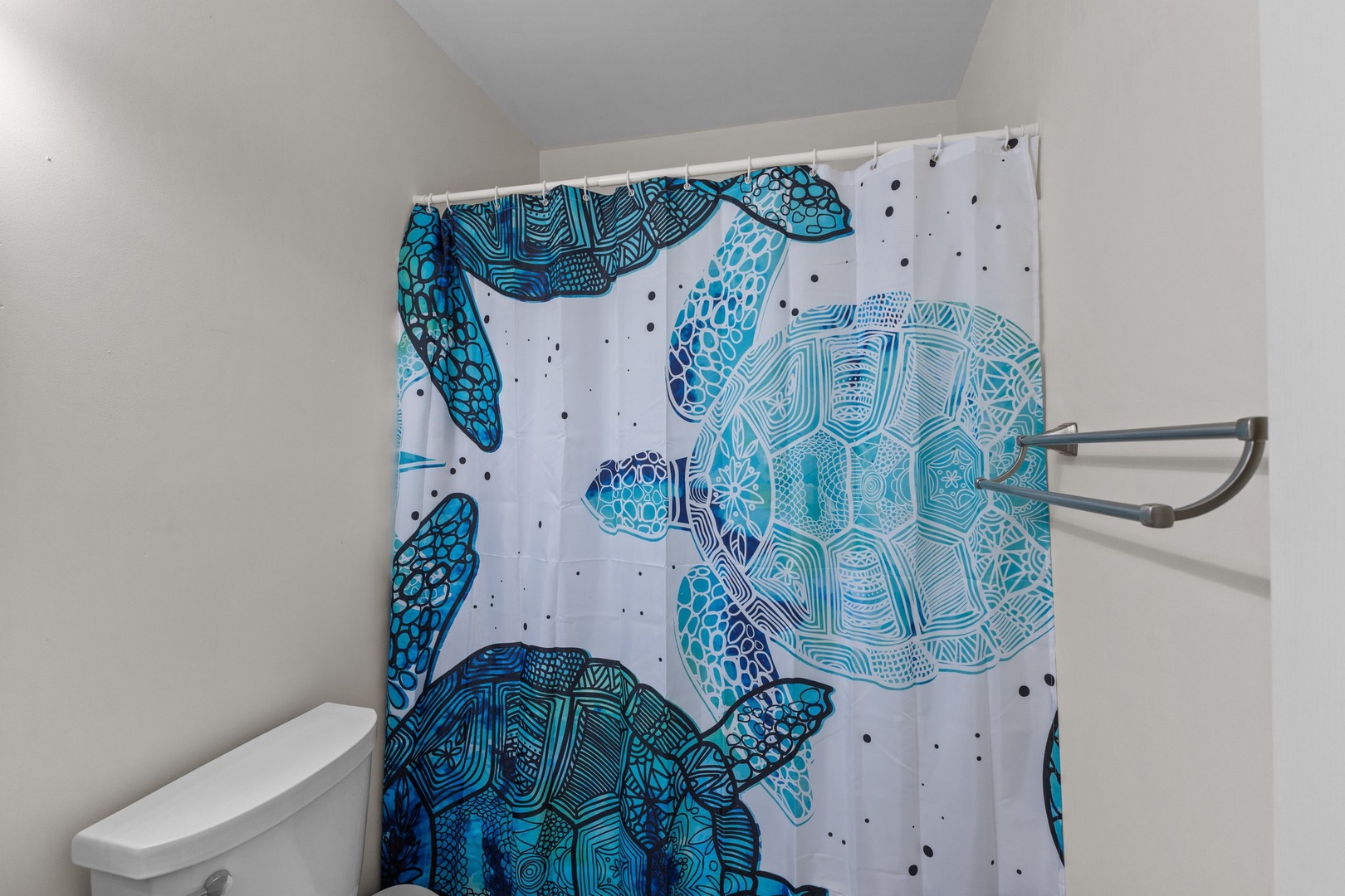 Step into your private bathroom where ocean-inspired sea turtle curtains create a coastal escape while you refresh.