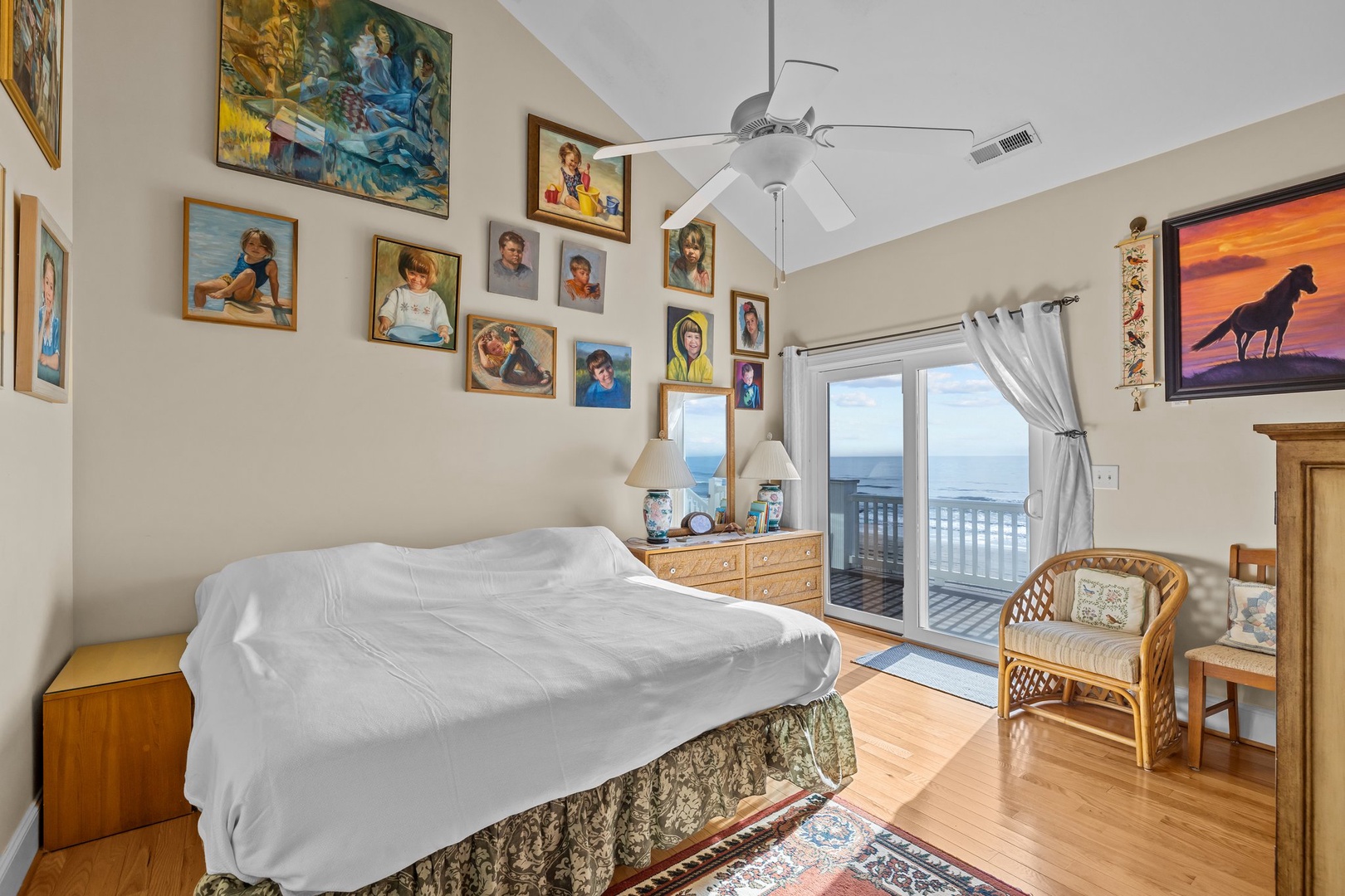 Wake up to ocean views from your cozy bedroom, where family photos and artwork create a personal, welcoming atmosphere.