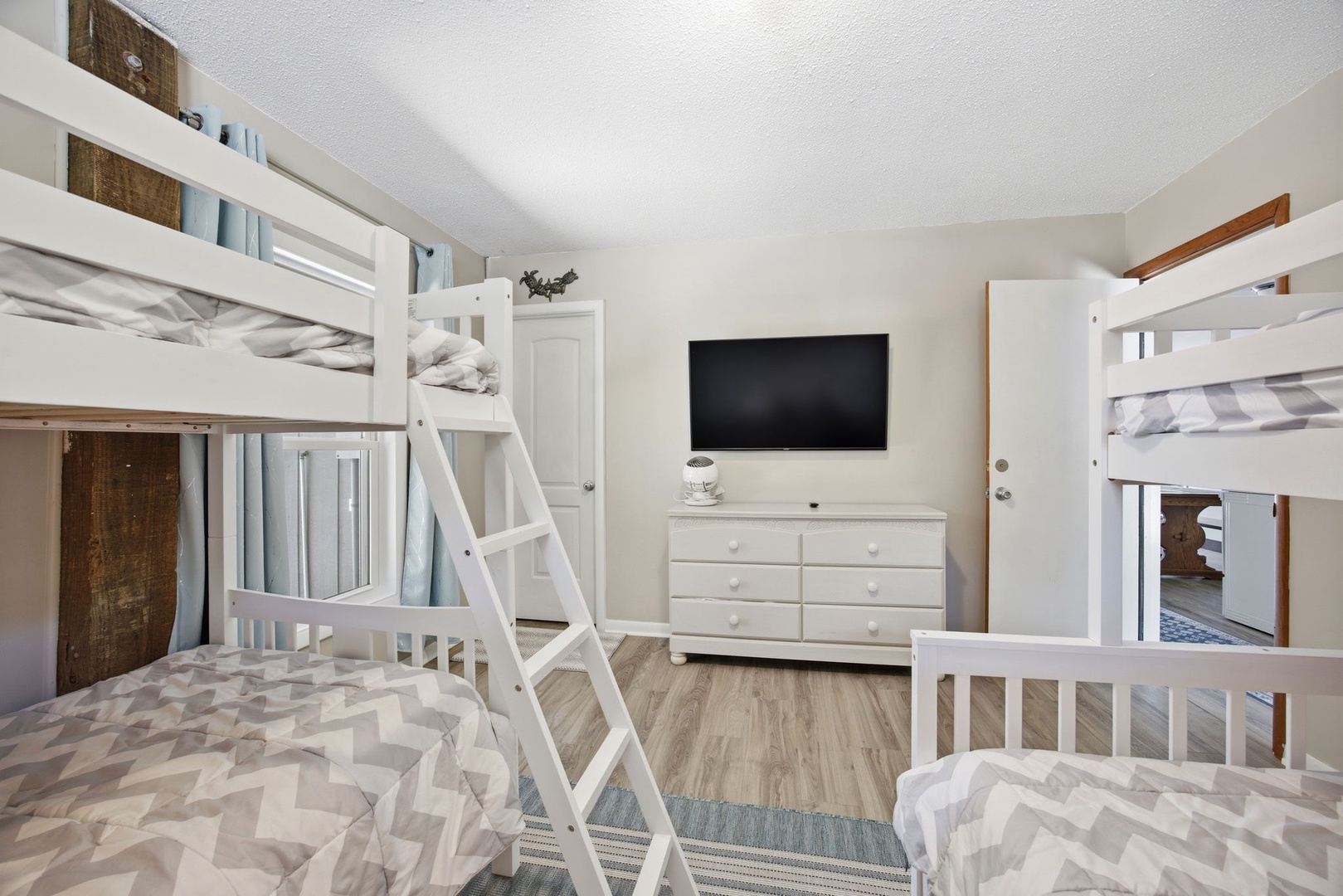 Your group will love this fun bunk room with multiple beds, entertainment center, and plenty of space to unwind together.
