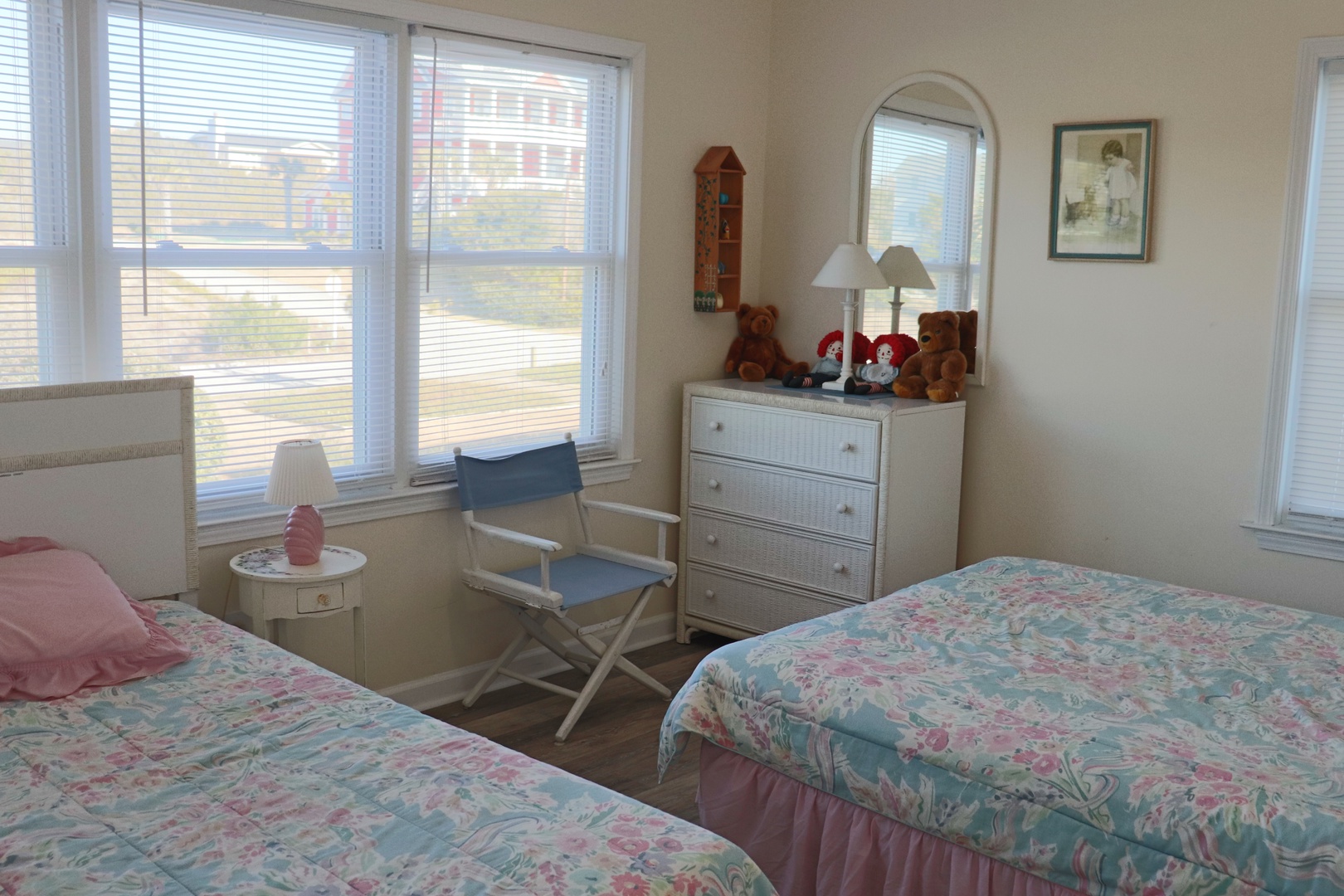 Drift off peacefully in your charming twin bedroom, where morning light filters through white blinds and teddy bears add whimsical touches.