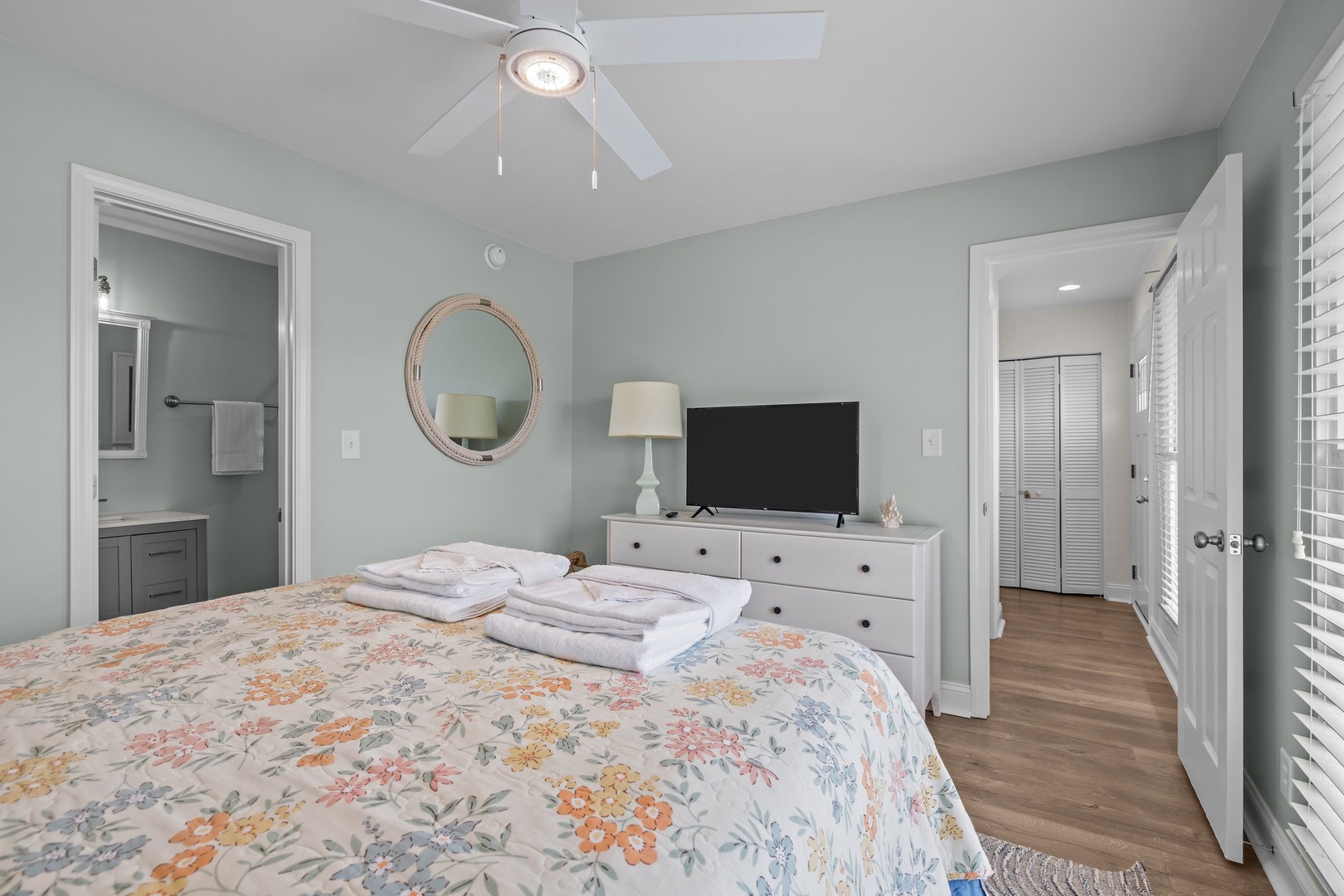 Your peaceful bedroom features soothing sage walls, fresh linens, and a gentle ceiling fan to keep you comfortable throughout your stay.