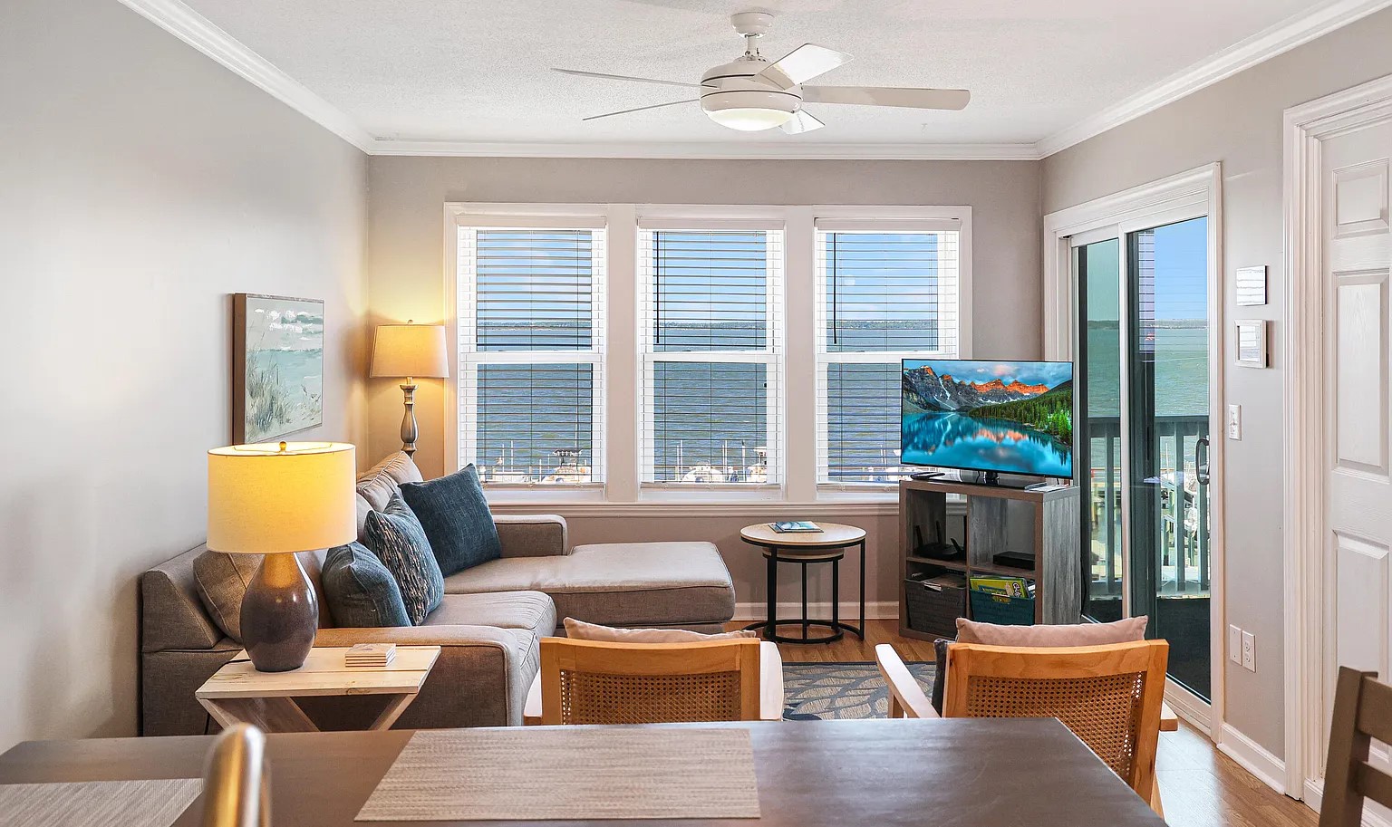 Relax in your bright living space with coastal views through large windows, comfortable seating, and all the modern amenities you need.