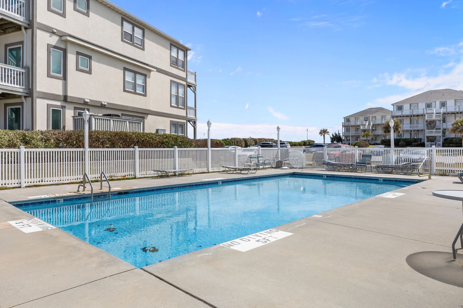 Crystal-clear pool waters await your perfect poolside day, surrounded by comfortable loungers and coastal charm.