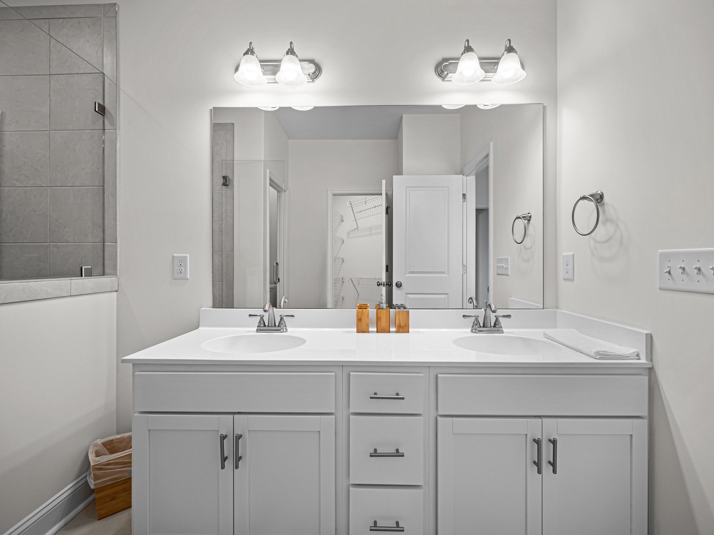 Your spacious bathroom features dual sinks with modern fixtures, perfect lighting, and plenty of storage for your essentials.