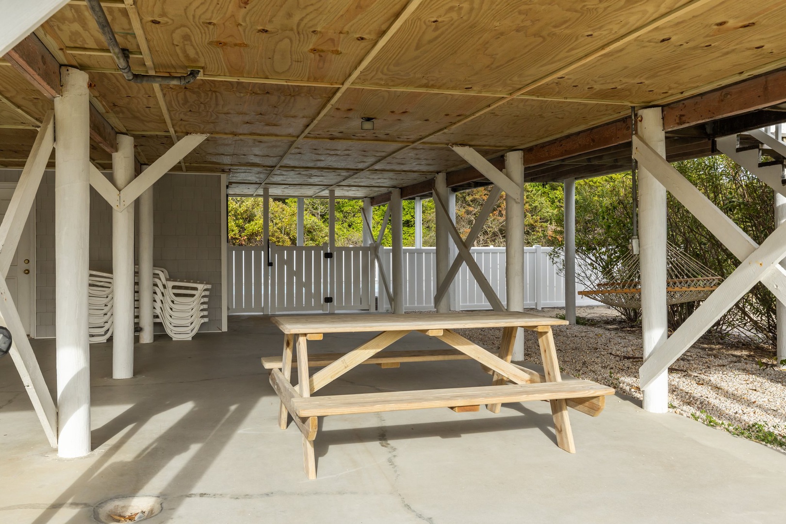 Your covered patio offers shade and comfort with a sturdy picnic table for outdoor dining and relaxation.
