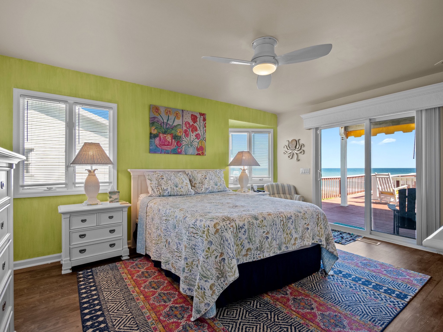 Wake to stunning sea views from your vibrant coastal bedroom, where comfortable furnishings and tropical charm create the perfect beachside retreat.
