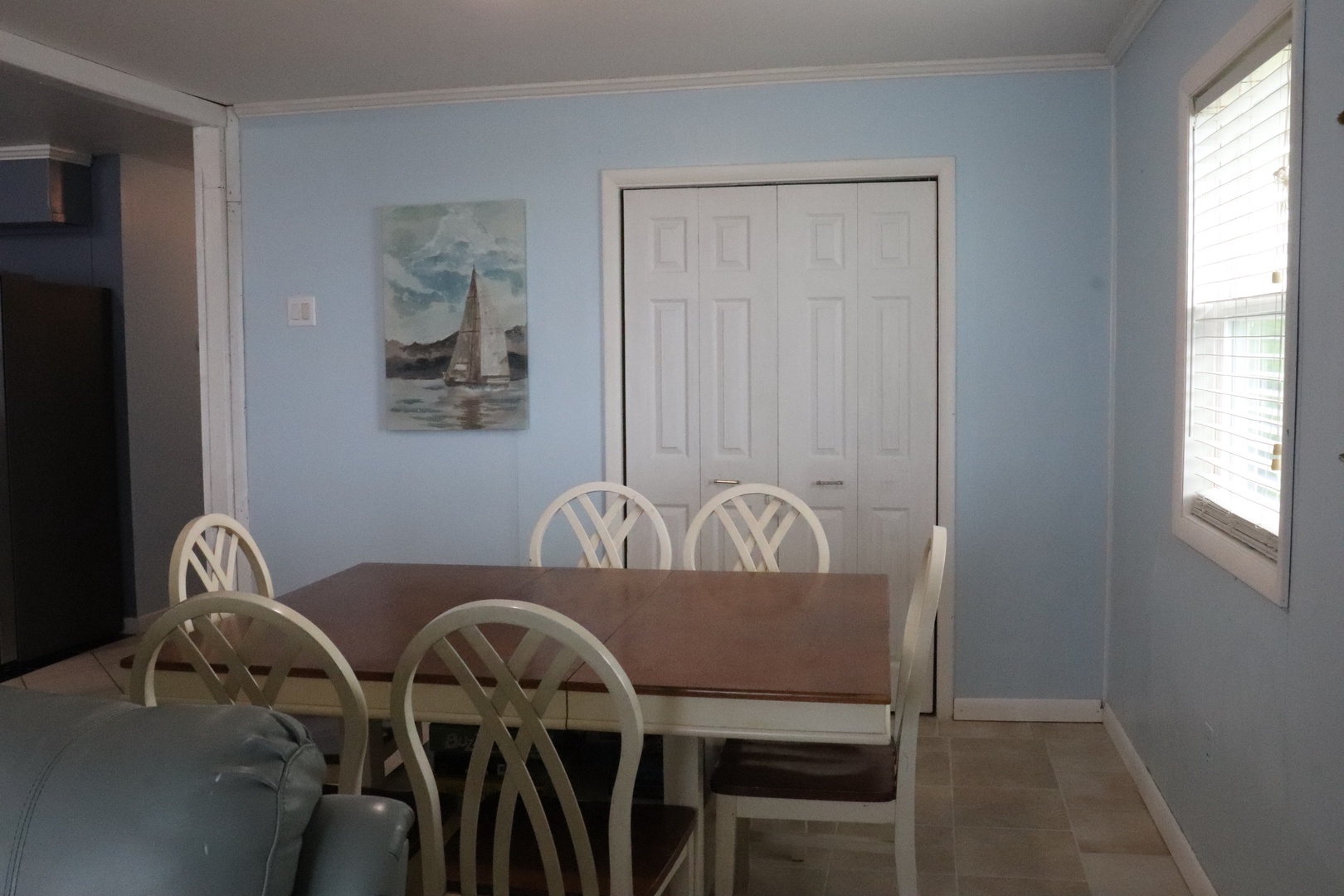 Gather around this welcoming dining table with seating for six, perfect for sharing meals and making memories together in your coastal retreat.