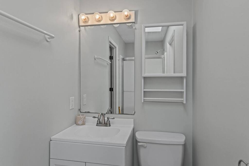Your private bathroom features bright vanity lighting and convenient storage for a refreshing start to each day.