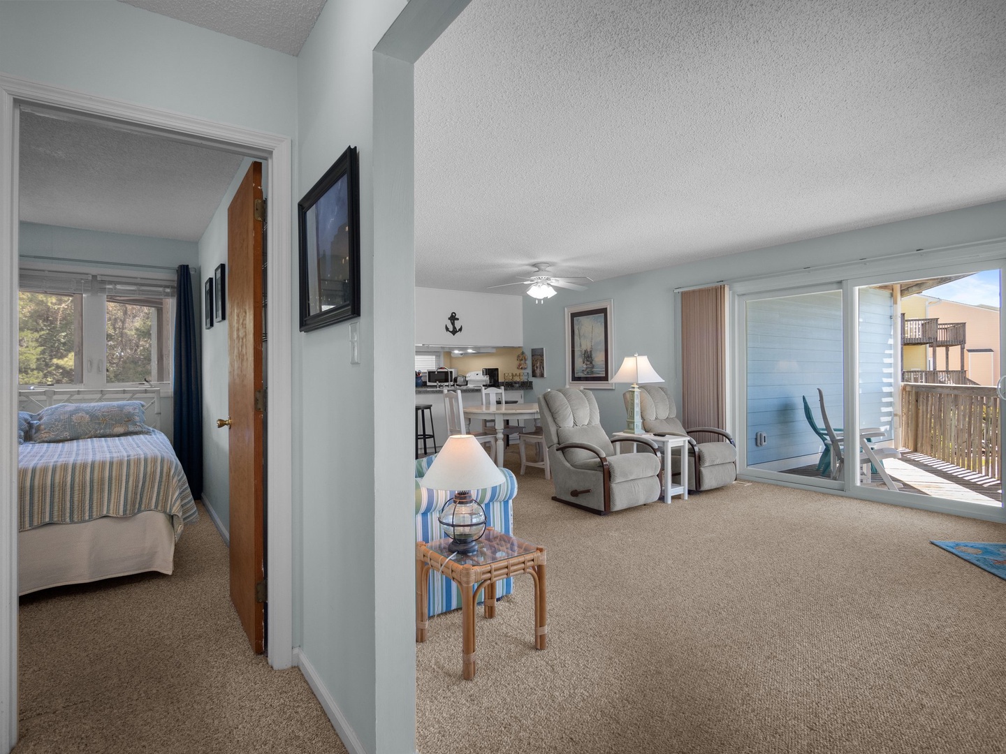 Relax in your spacious coastal retreat with comfortable recliners and stunning ocean views from your private balcony.