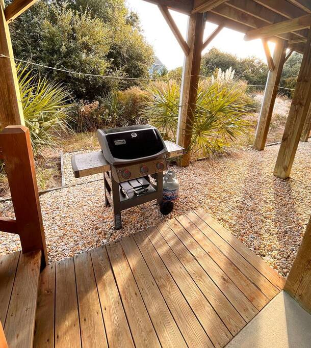 Your own outdoor kitchen awaits beneath the covered deck, with a premium BBQ grill surrounded by peaceful landscaped gardens perfect for outdoor dining.