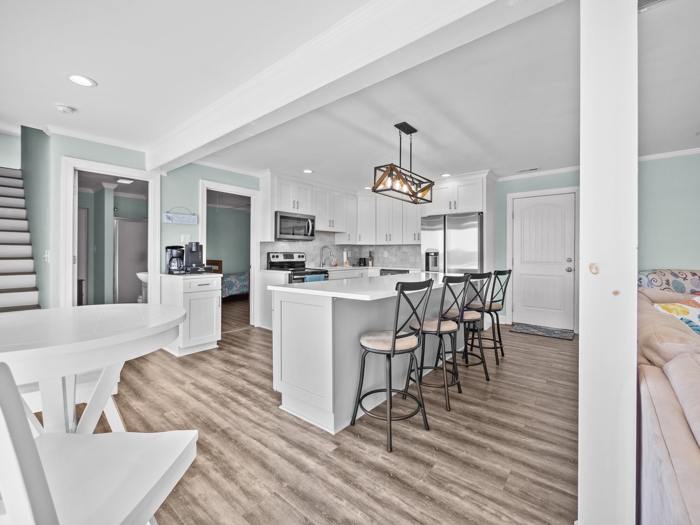 Your bright, modern kitchen features white cabinetry, stainless appliances, and a spacious island with comfortable bar seating for memorable meals.