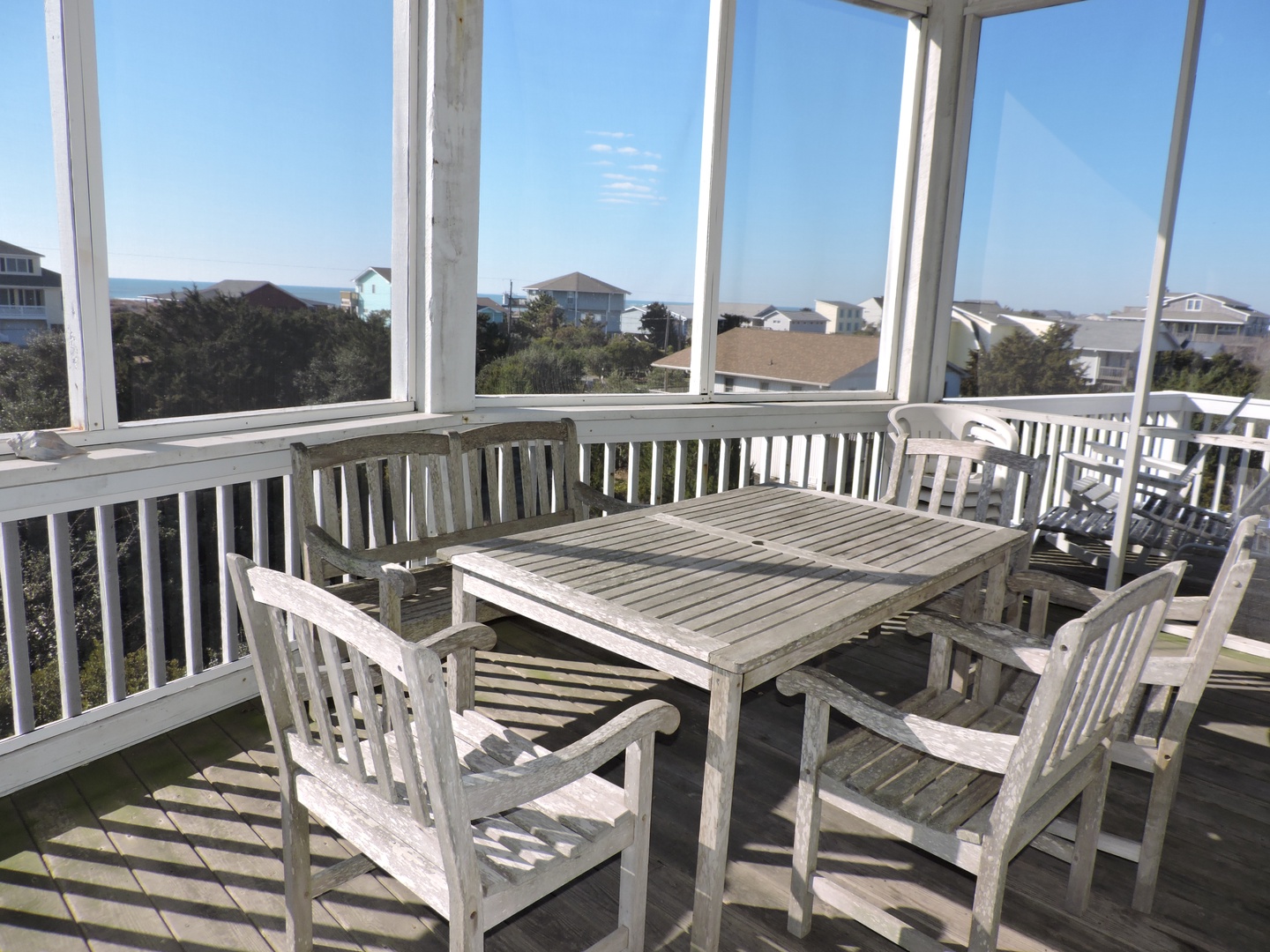 Enjoy morning coffee on your private screened porch with coastal views and gentle ocean breezes.