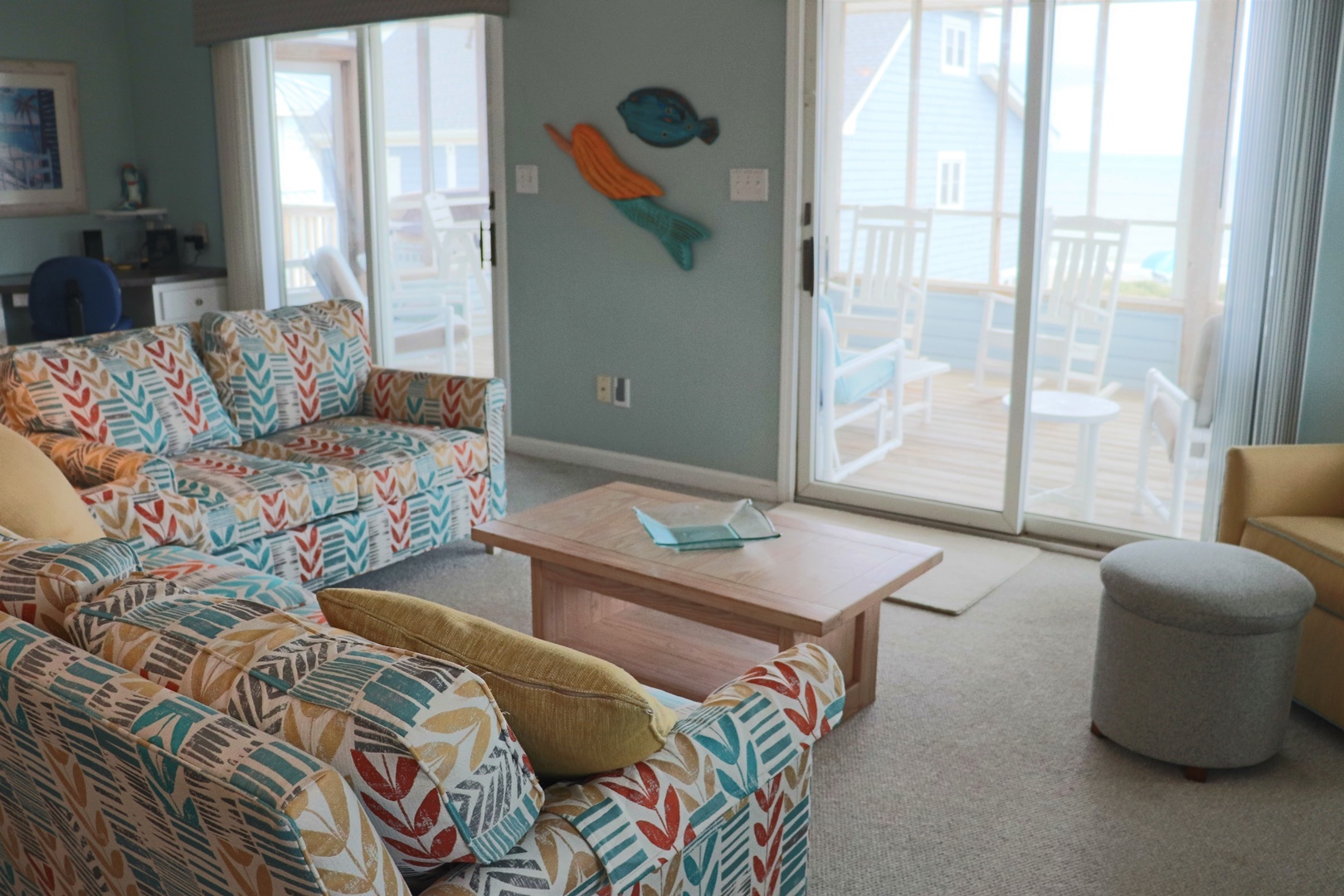 Sink into comfortable seating with ocean-inspired décor while natural light fills your coastal retreat through sliding doors to your private balcony.