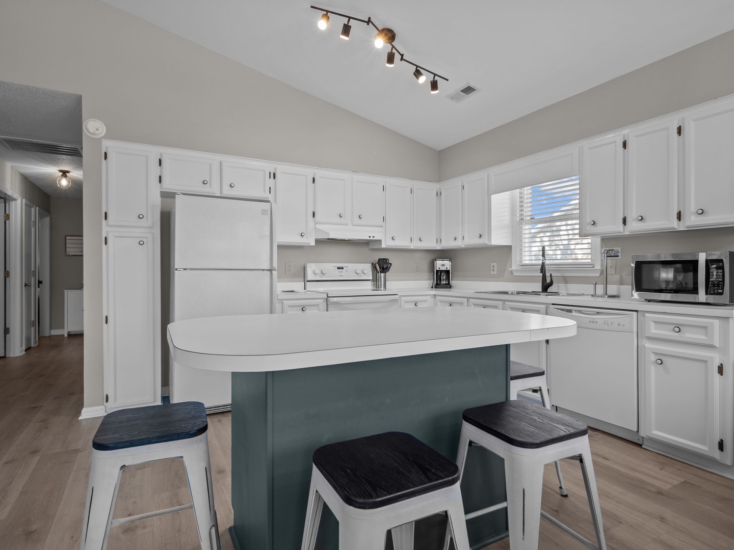 Your fully equipped kitchen features modern appliances, ample counter space, and a welcoming island where you can gather for meals and conversations.