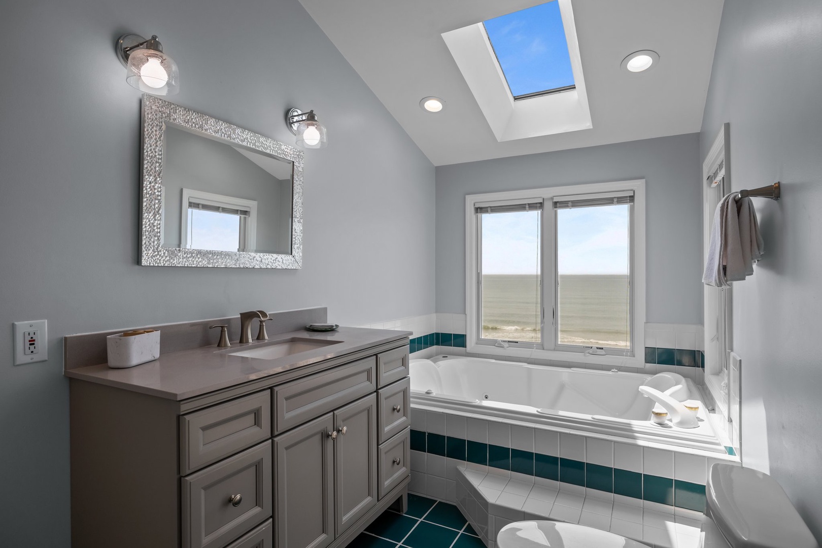 Soak in your private spa-like bathroom with natural light from the skylight and beautiful views beyond.