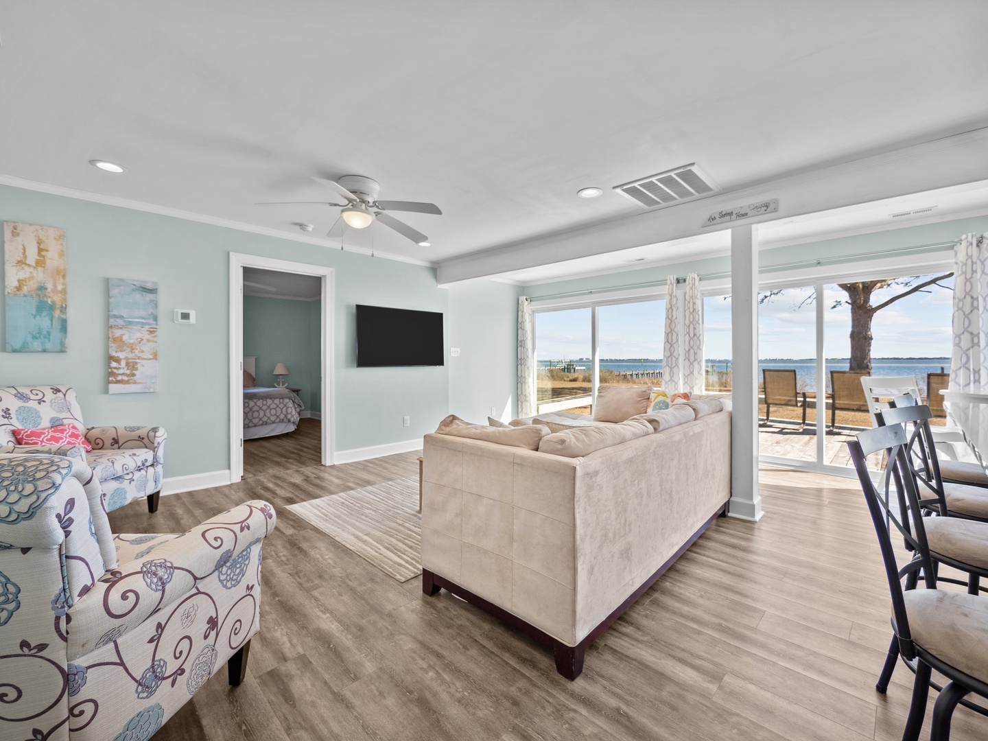 Unwind in your bright oceanfront living room where sea views flow through floor-to-ceiling windows and gentle breezes from your private deck create the perfect coastal retreat.