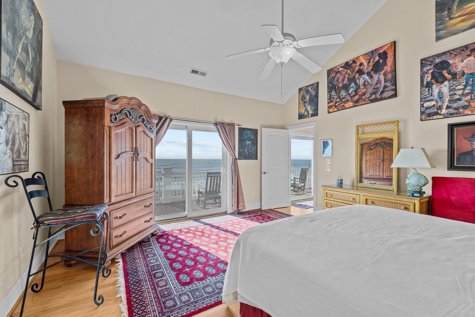 Wake up to stunning ocean views from your beautifully appointed bedroom, where colorful artwork and thoughtful furnishings create a perfect seaside retreat.