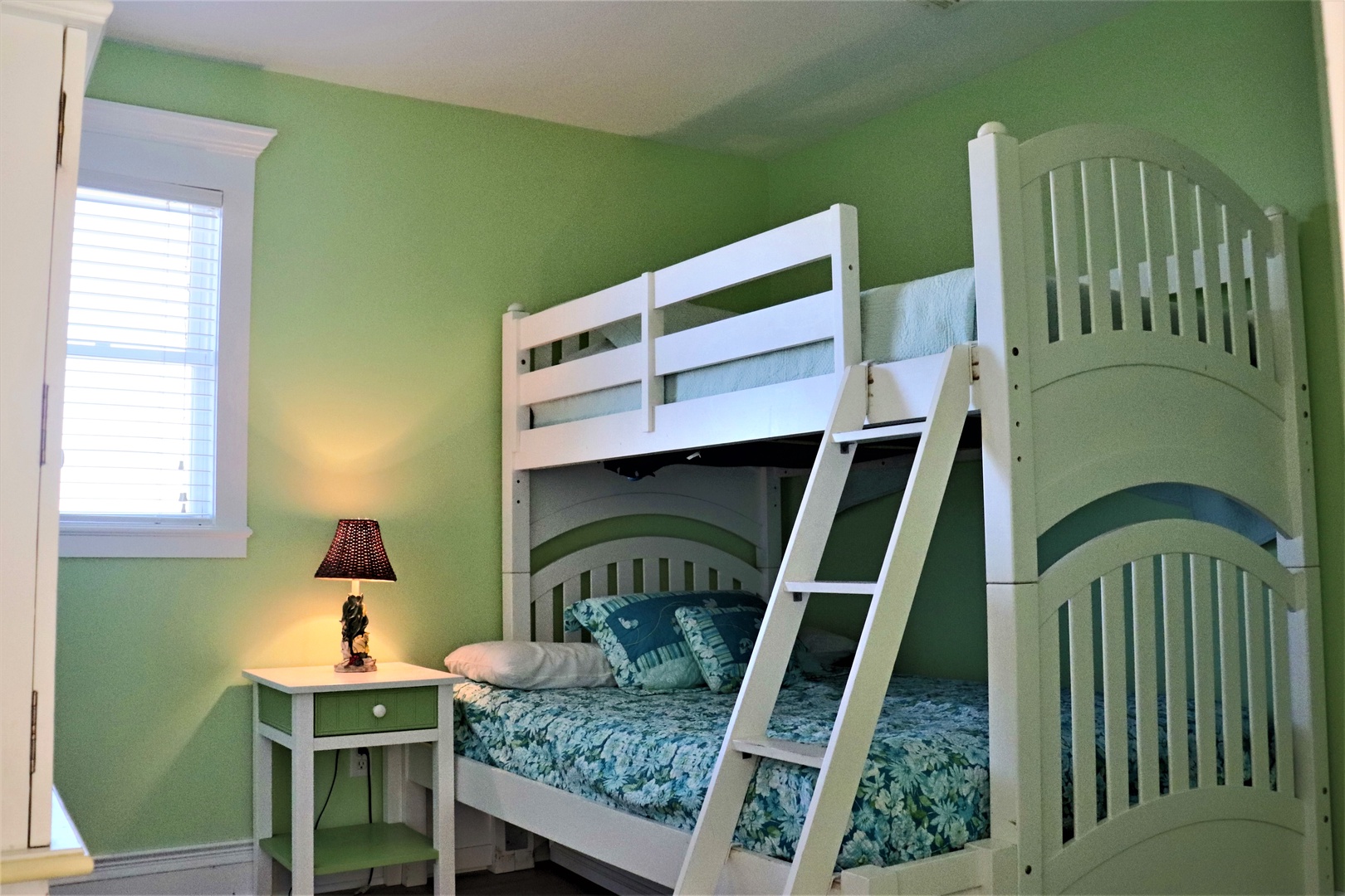 Cozy bunk beds in cheerful green create the perfect space for your family's restful nights together.