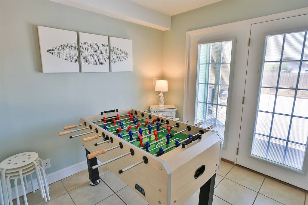 Challenge friends to exciting foosball matches in this bright game room, complete with comfortable seating and patio access for breaks.