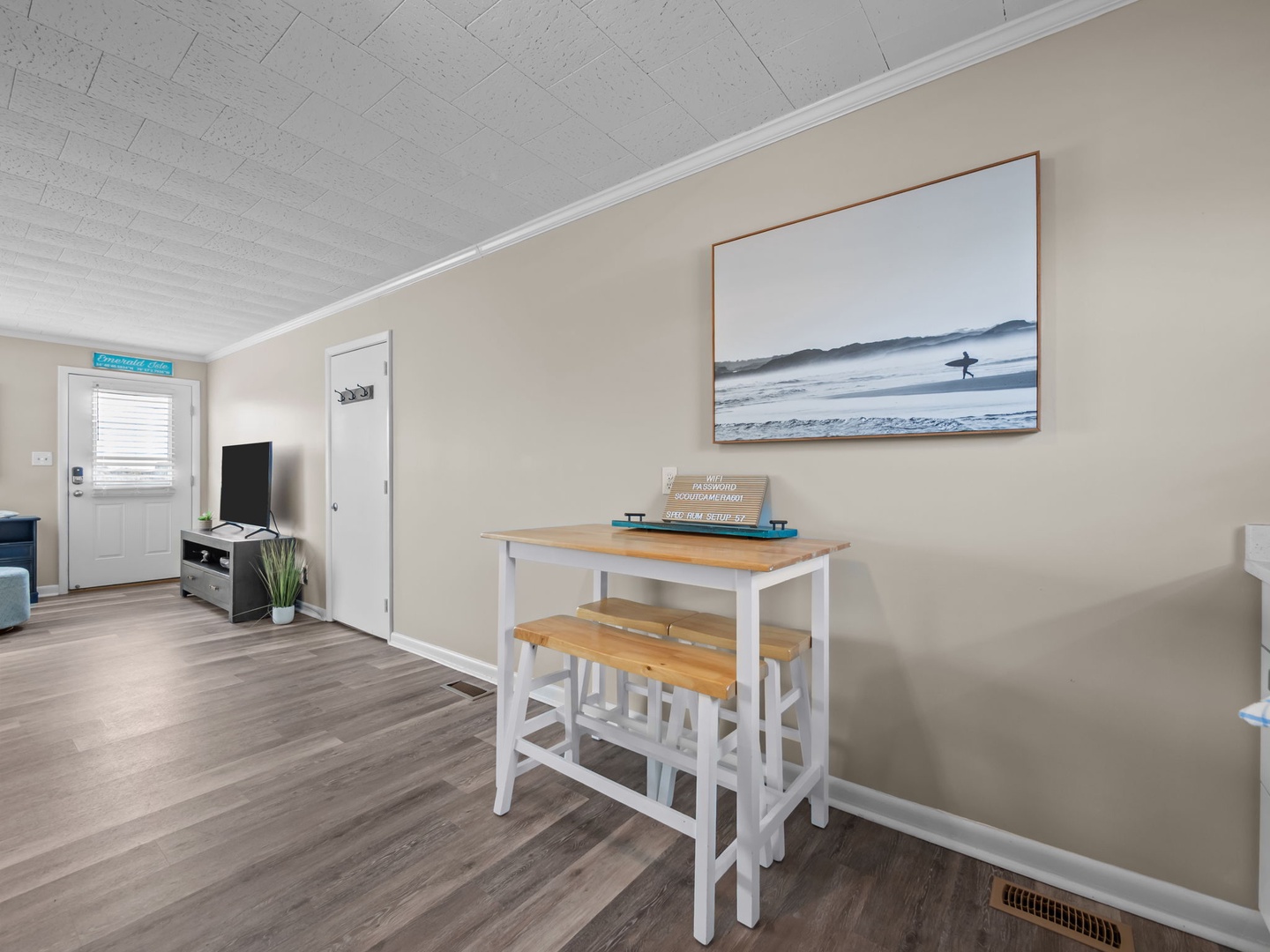 Relax in your bright, coastal-themed space with a cozy dining nook and entertainment setup for peaceful mornings and evenings.