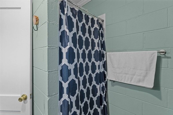 Step into your private bathroom with fresh mint walls and stylish geometric patterns that create a calming retreat.