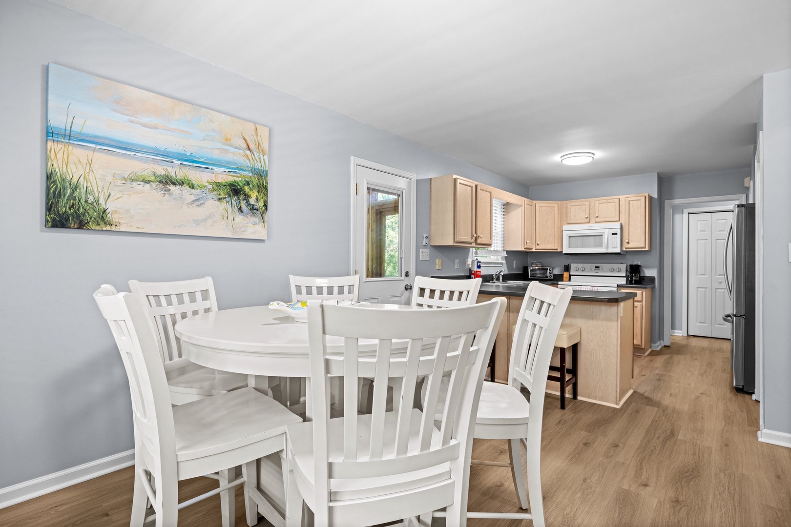 Your bright dining area flows seamlessly into the fully equipped kitchen, perfect for preparing meals and gathering with loved ones.