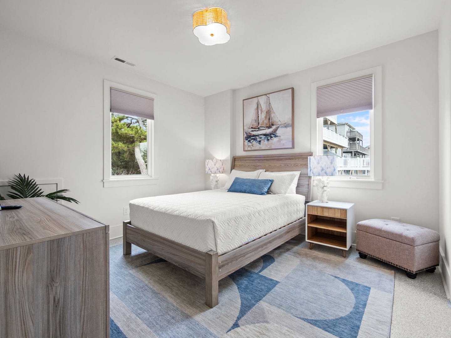 Your nautical-themed bedroom features coastal charm with warm wood tones, ocean-blue accents, and peaceful natural light.