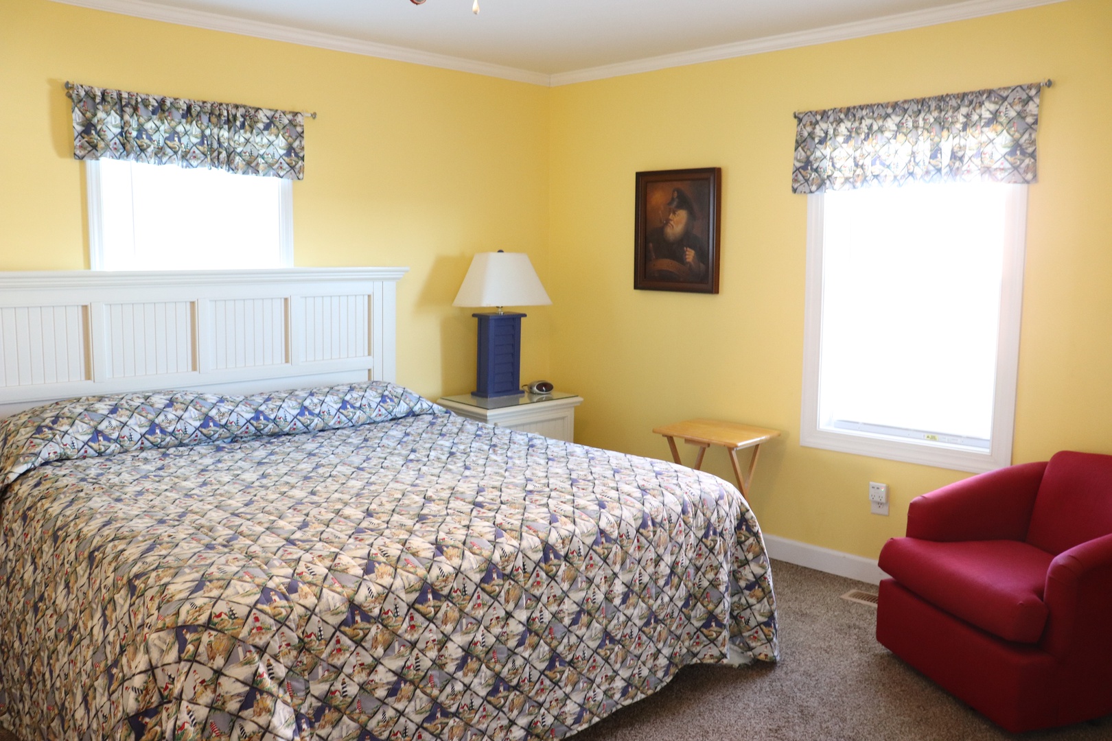 Unwind in your cheerful bedroom where sunny yellow walls and coordinated blue linens create the perfect retreat for restful nights.