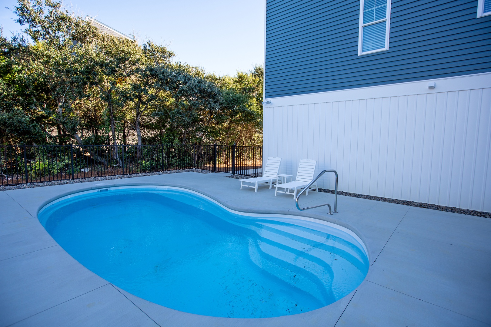 Take a refreshing dip in your private pool surrounded by peaceful trees and comfortable loungers for ultimate relaxation.