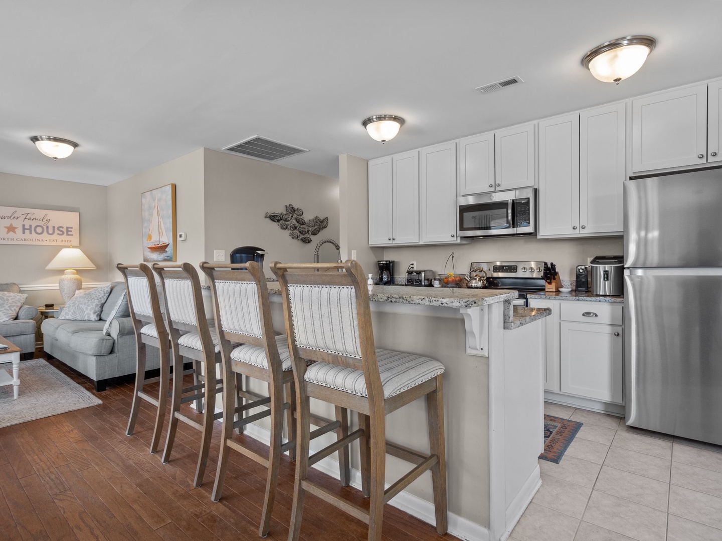 Your fully-equipped kitchen features granite counters and breakfast bar seating for four, perfect for morning coffee or casual meals together.