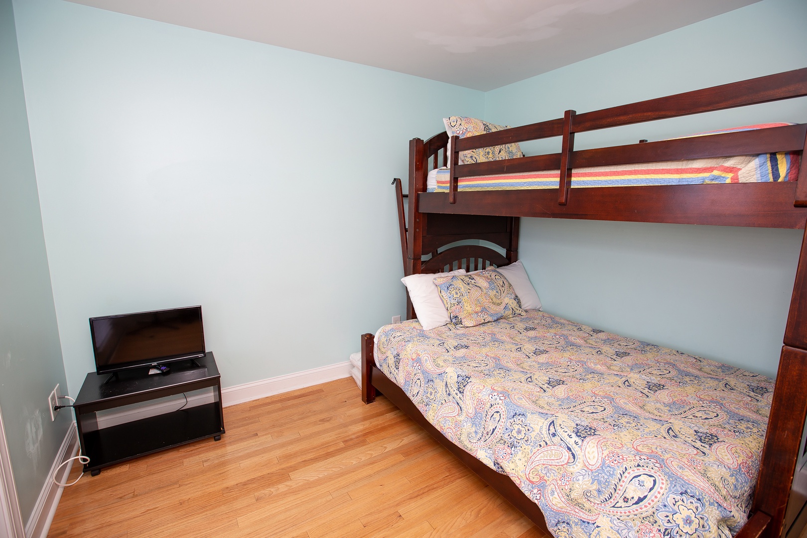 Your kids will love this cozy bunk bed room, complete with TV entertainment and warm wood floors for comfortable stays.