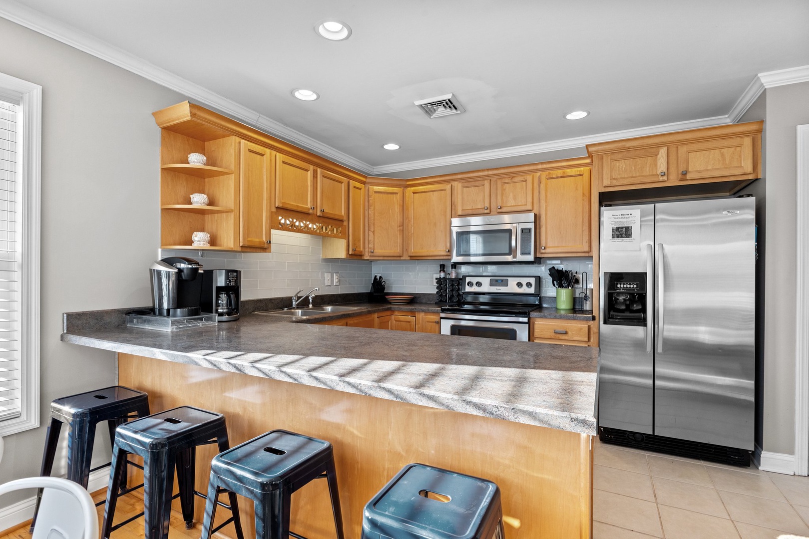 Your fully equipped kitchen features granite countertops, stainless steel appliances, and a breakfast bar where you can savor morning coffee or prepare meals together.
