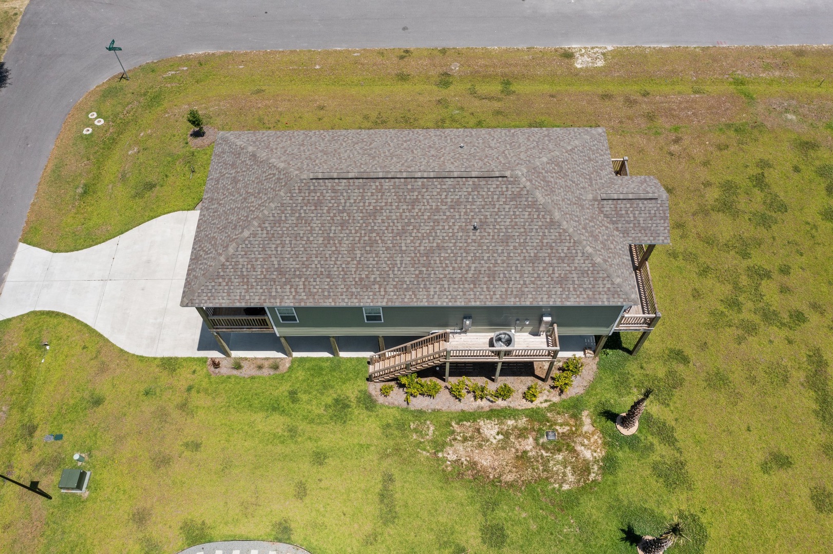 Aerial view of the vacation rental property showcasing the spacious grounds and peaceful rural setting with convenient driveway access.