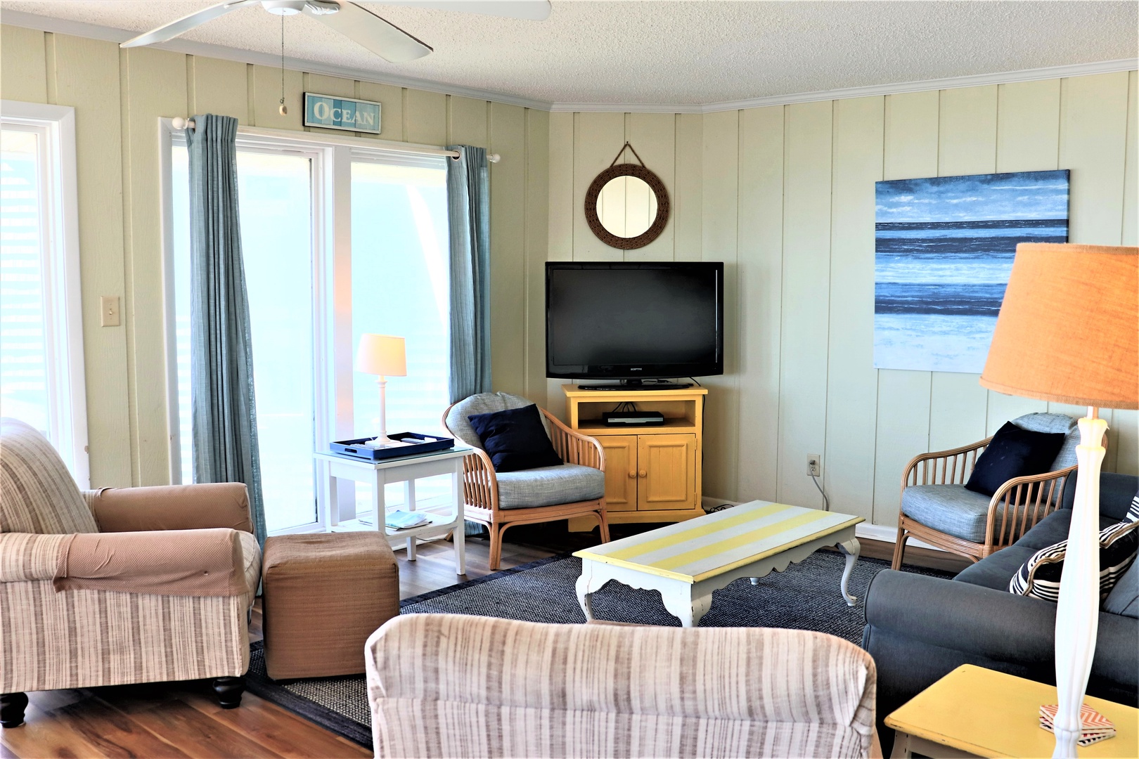 Sink into coastal comfort in your bright living room, where ocean artwork and nautical touches create the perfect beach retreat.