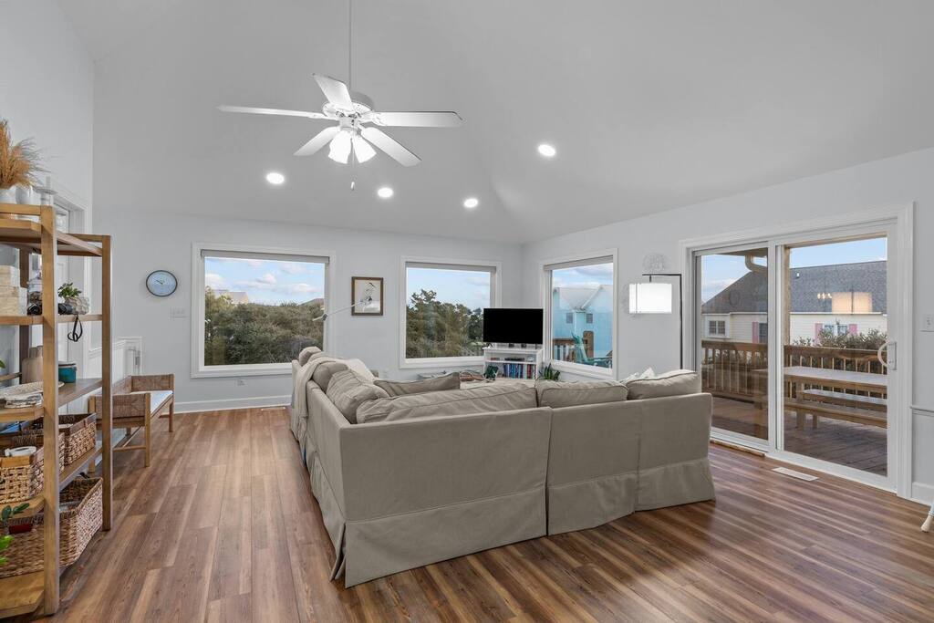 Relax in your spacious living room with vaulted ceilings and natural light streaming through large windows.