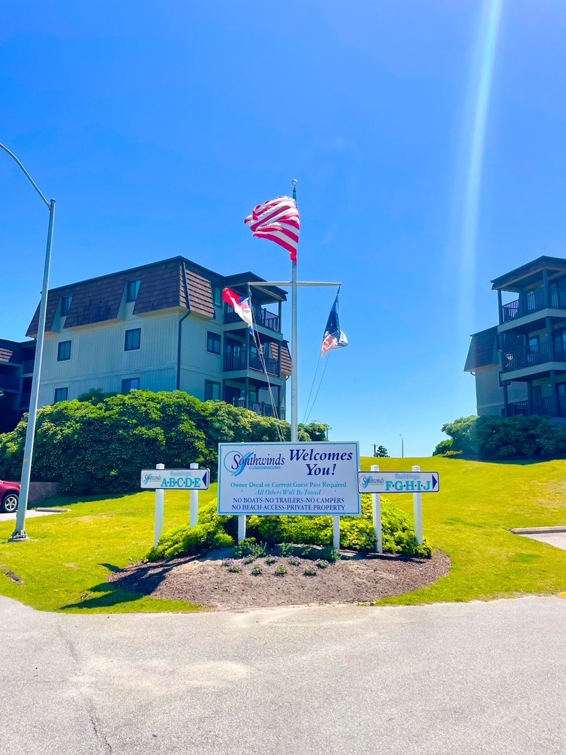 Southwinds resort entrance featuring coastal buildings and welcome signage under clear blue skies.