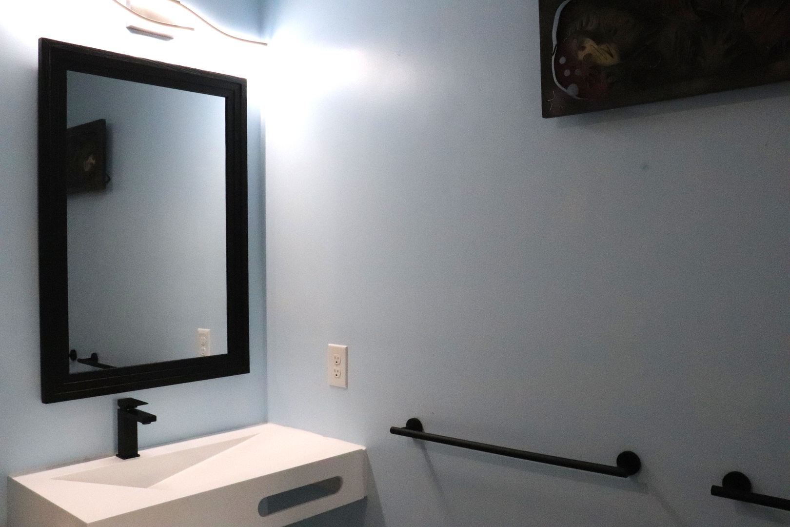 Modern bathroom with sleek black fixtures and crisp white vanity, perfect for refreshing before your next adventure.