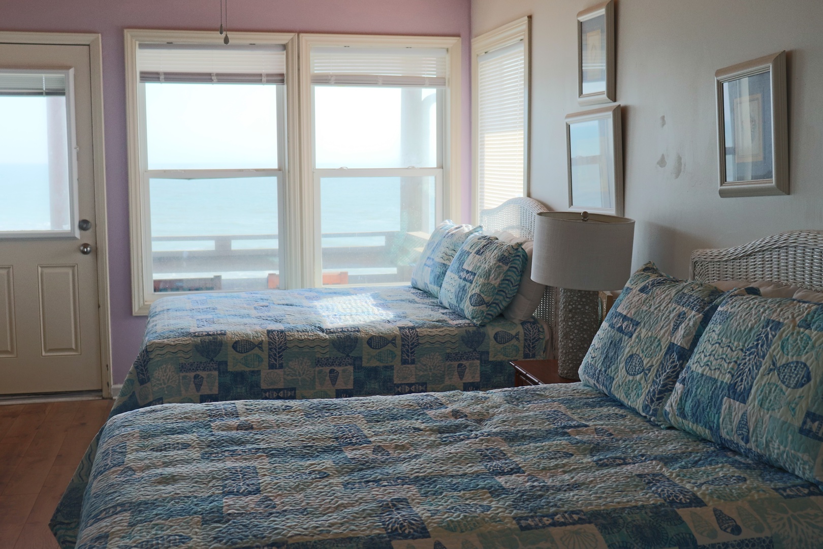 Wake up to ocean views in your cheerful twin bedroom with coastal quilts and private balcony access.