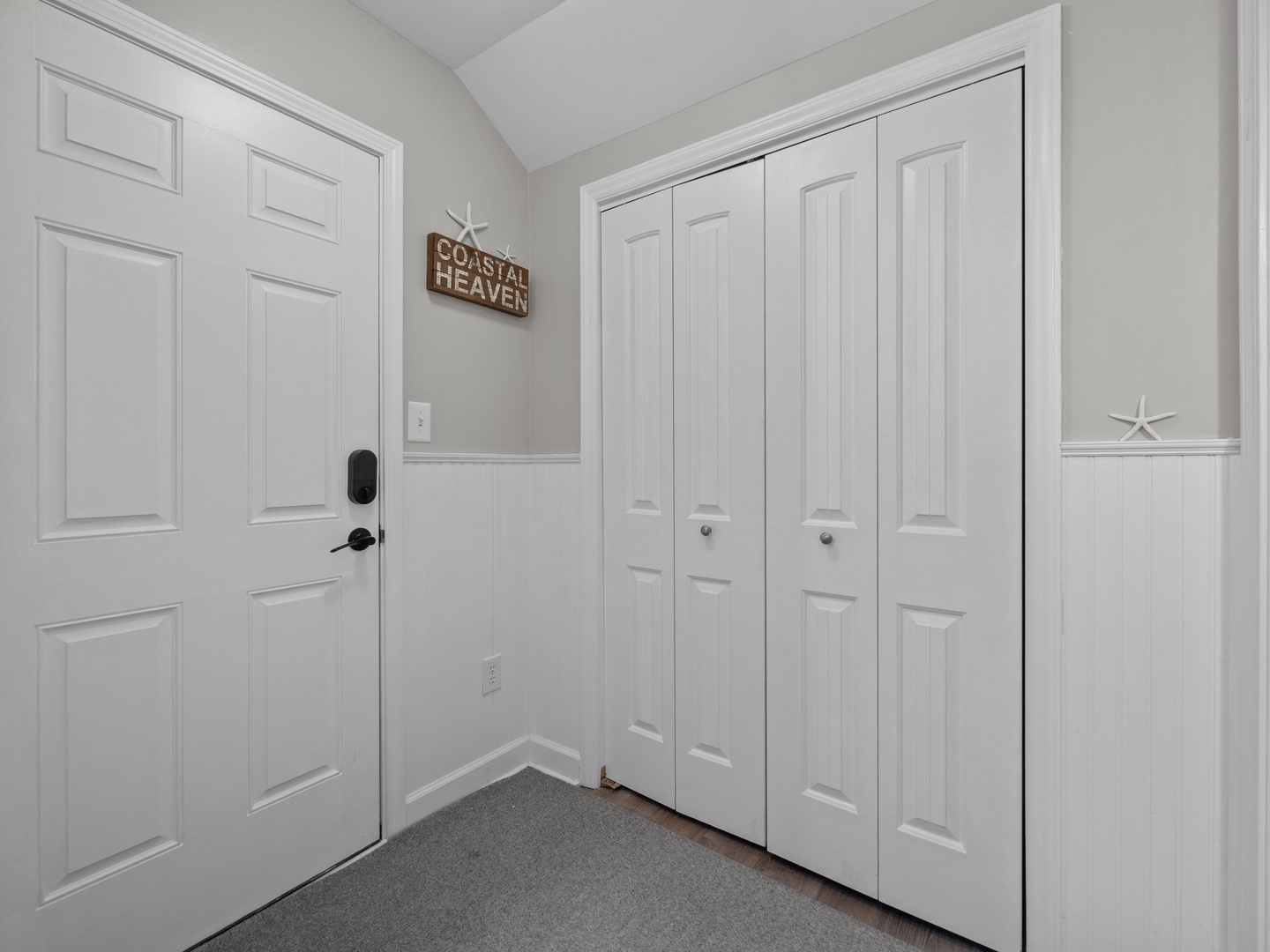 Step into your coastal retreat through this welcoming entryway, where thoughtful touches and ample storage await your arrival.