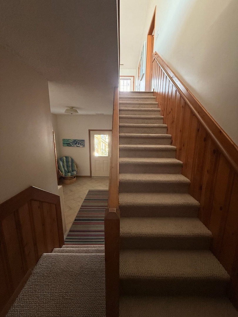 Step into your home-away-from-home through this inviting entrance with warm wood accents and a welcoming staircase that leads to your upstairs retreat.